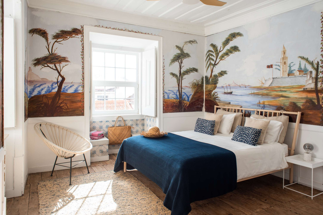 Santo Antonio 2 charming bedroom with a painted mural of a coastal scene.