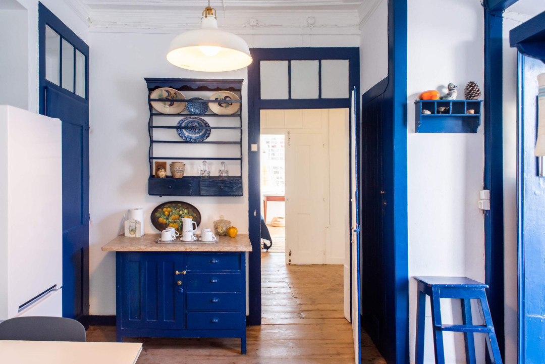 Santo Antonio 2 charming, cozy kitchen with rich navy blue cabinetry and vintage accents.