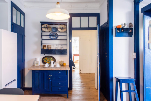 Santo Antonio 2 charming, cozy kitchen with rich navy blue cabinetry and vintage accents.