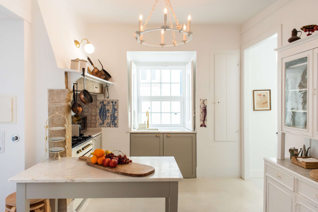 Santo Antonio 1 light-filled kitchen, featuring a large window and a charming island