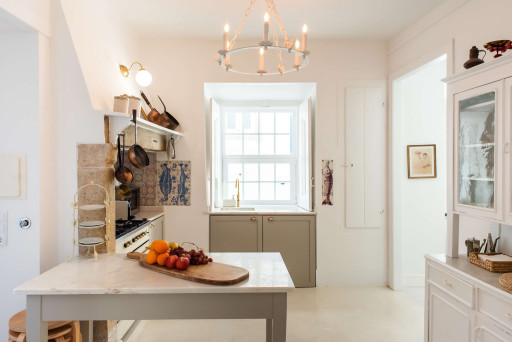 Santo Antonio 1 light-filled kitchen, featuring a large window and a charming island