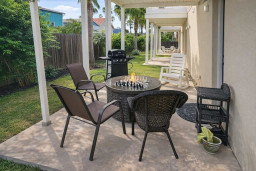 Relaxing Patio Retreat with Fire Pit, Grill & Chess Table – Perfect for Outdoor Lounging and Social Evenings
