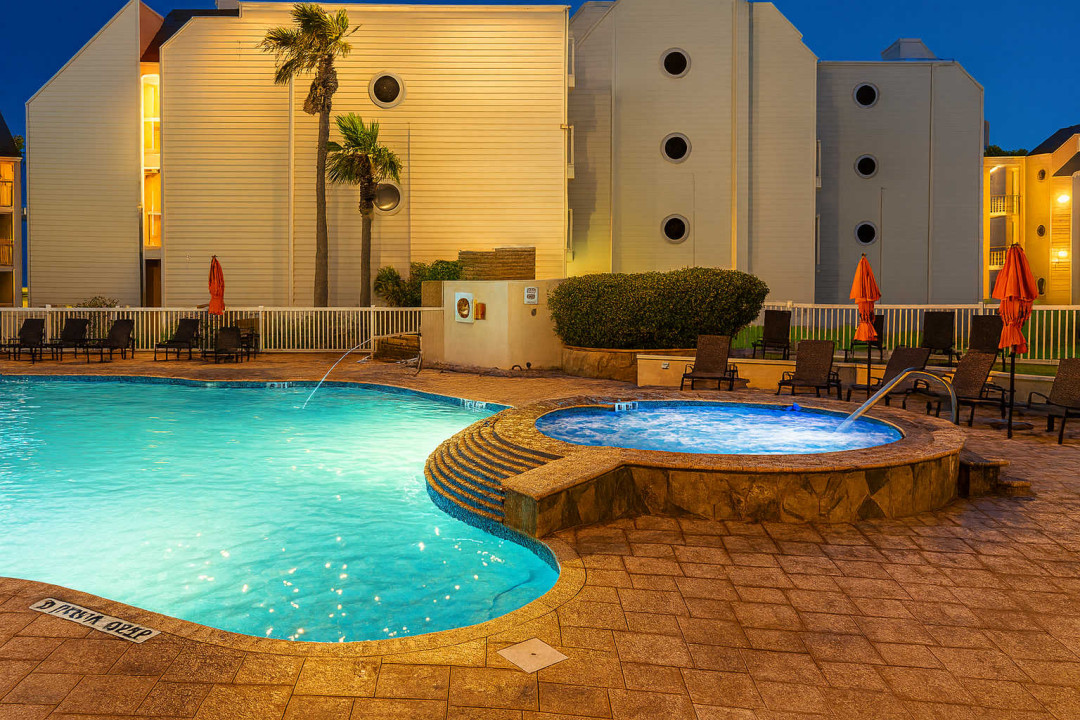 Delight in poolside relaxation at this oceanfront condo featuring a sparkling swimming pool, inviting tub, and stylish loungers. After a day at the beach, unwind in comfort with expansive outdoor amenities and tranquil coastal views.