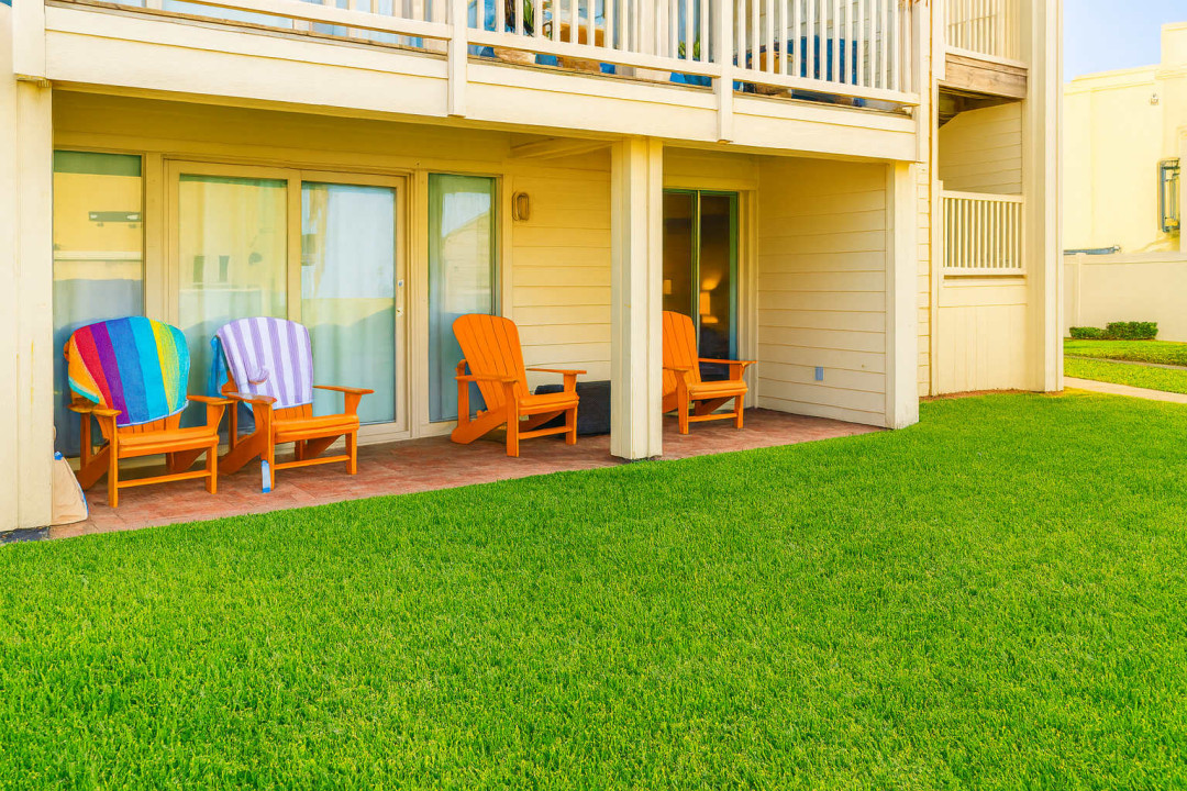 Enjoy peaceful mornings on your beautiful patio with garden views in this charming South Padre Island condo. Perfect for unwinding after a day at the beach, the space provides comfortable outdoor seating and direct access to lush green surroundings.