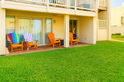 Enjoy peaceful mornings on your beautiful patio with garden views in this charming South Padre Island condo. Perfect for unwinding after a day at the beach, the space provides comfortable outdoor seating and direct access to lush green surroundings.