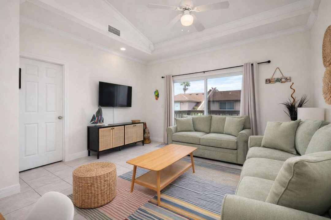Bright Coastal Retreat w/ Balcony, Palm Views & Stylish Decor – Walk to Beach, Dining & Shops