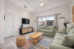Bright Coastal Retreat w/ Balcony, Palm Views & Stylish Decor – Walk to Beach, Dining & Shops