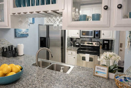 Modern Coastal Kitchen with Granite Counters, Stainless Appliances & Beachy Accents – Perfect for Relaxing Getaways