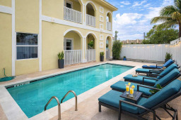 Relax by the Outdoor Pool at This Bright 2BR Coastal Retreat — Steps from Dining & Beaches