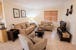 Cozy Living Room Retreat – Bright, Clean, and Inviting with Stylish Seating, Smart TV, and Natural Light