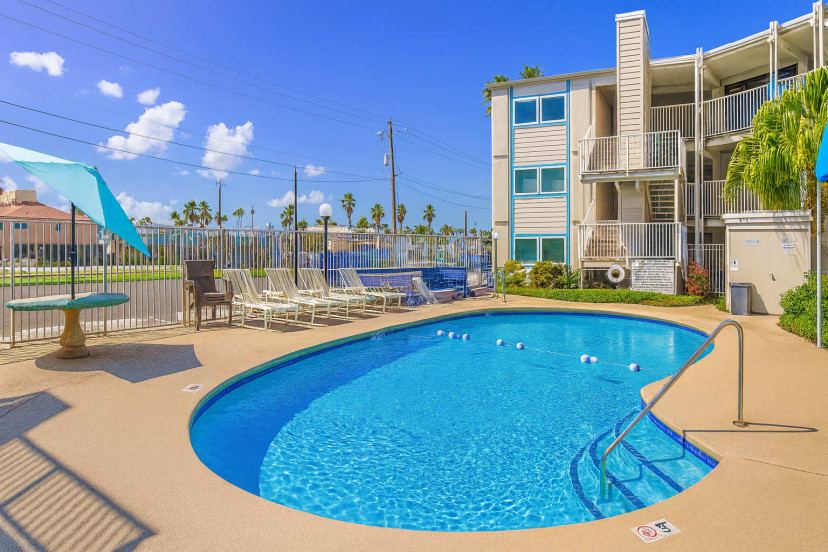 Relax by the sparkling outdoor pool, perfect for cooling off under the Texas sun. With lounge chairs, shaded seating, and a refreshing atmosphere, it’s the ideal spot to unwind after a beach day or start your morning swim.