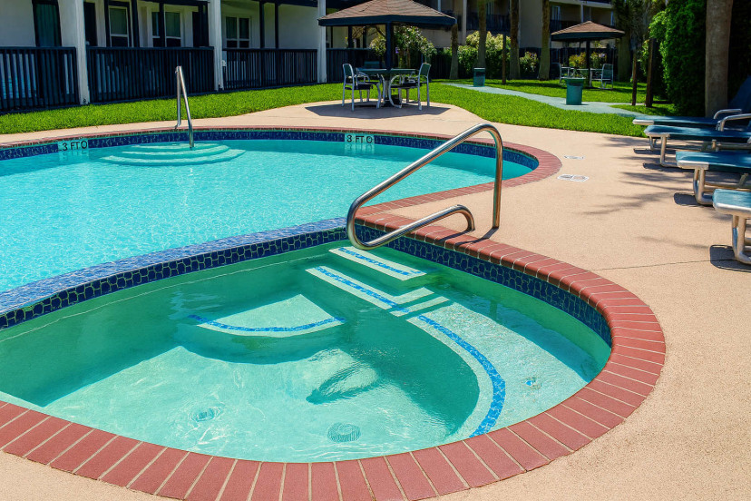 Sparkling Lagoon Pool & Spillover Spa
Tropical Waterside Bliss. Curved azure pool flows into inviting tub w/ brick edging, chrome rails & lush greenery backdrop. Ultimate chill spot—swim, soak & savor Florida sun in this garden paradise!