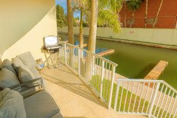 Lagoon-View Outdoor Lounge
Relax on cushy lounge seating on the private terrace overlooking tranquil lagoon waters and palm trees. Fire up the built-in grill for sunset dinners—steps to dock, pure waterfront living at its finest!