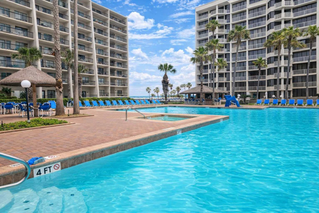 Beachfront resort condo with stunning pool, shaded palapas, and lounge deck—steps from the sand and perfect for families or couples seeking a tropical escape. Enjoy ocean views, water slide, and palm-lined relaxation in South Padre Island.