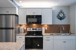 Modern Coastal Kitchen | Stainless Steel Appliances | Granite Counters | Nautical Decor | Bright & Clean | Perfect for Beach Getaways