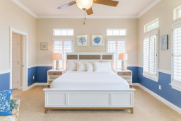 Relax in this bright, spacious bedroom featuring a comfortable bed, ample natural light, beach-inspired décor. Enjoy peaceful mornings with sunlight streaming through large windows—perfect for unwinding after a sun-filled day on South Padre Island.