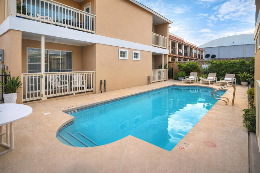 Relax by the sparkling pool in this cozy courtyard retreat—ideal for sun-soaked getaways, family stays, or weekend escapes near the beach.