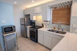 Modern Kitchen with Stainless Steel Appliances, Dual Sink, Coffee Station & Microwave Cart – Bright, Clean, and Fully Equipped for Your Stay