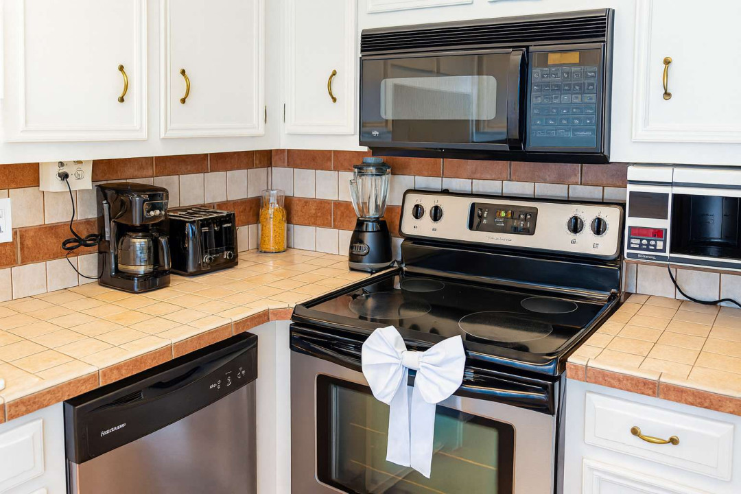 Fully Equipped Coastal Kitchen Haven
Spotless white cabinet kitchen in South Padre beach rental! Shiny black appliances, dishwasher, microwave, coffee maker, blender. Spacious counters, tiled backsplash for easy prep.