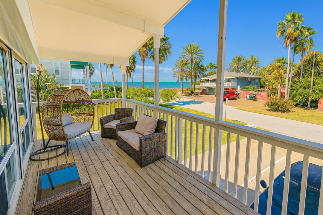 Breathtaking Oceanfront Deck Serenity
Expansive balcony deck in South Padre Island gem! Wicker hanging chair, loveseat, coffee table under shady cover. Direct Gulf views, swaying palms, beach access. Sip cocktails, watch sunsets or SpaceX launches!