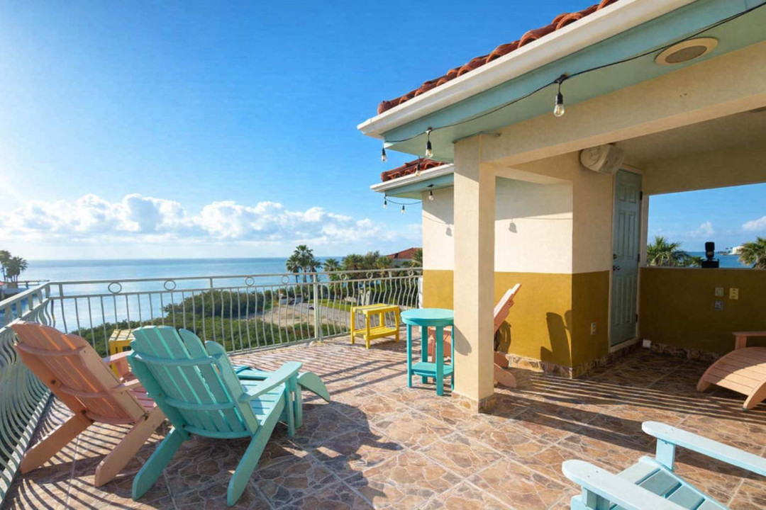 Oceanview Rooftop Patio with Pastel Seating & String Lights – Steps to Beach, Perfect for Sunset Lounging & Morning Coffee
