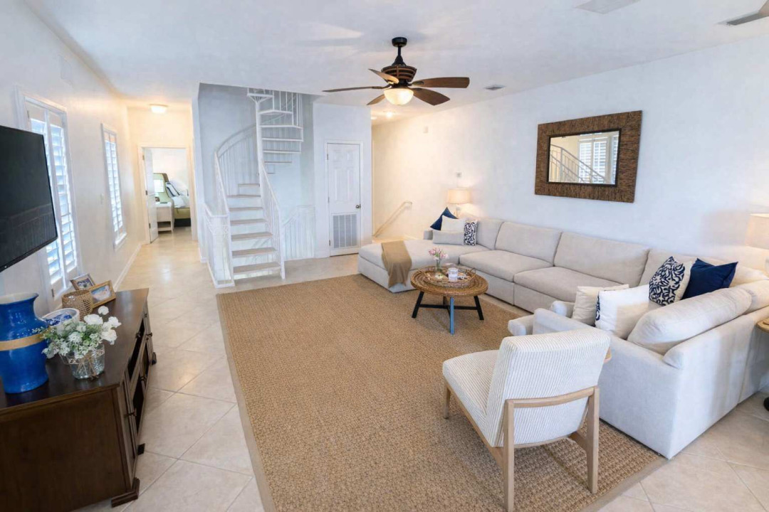 Bright Coastal Living Room w/ Spiral Staircase, Smart TV, Comfy Seating & Stylish Decor – Steps to Bedroom & Upper Level