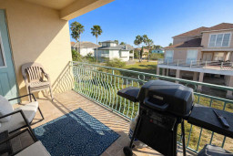 Sunny Balcony Retreat with Grill & Coastal Views — Steps from Beach, Palm-Lined Neighborhood, and Elevated Deck Homes