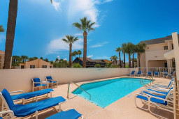 Unwind poolside under palm trees at Sea Dancer #1! This inviting retreat features plenty of sun loungers, a sparkling pool, and peaceful tropical vibes. Ideal for relaxing after beach adventures or enjoying quiet afternoons with loved ones.