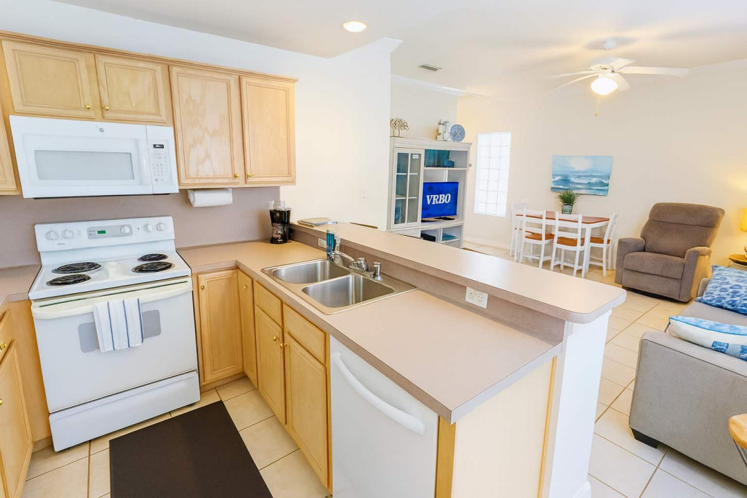 Enjoy a spacious open-concept kitchen and living area at Sea Dancer #1! Cook with ease in the fully equipped kitchen, dine together at the table, and relax in cozy seating—perfect for family meals and downtime after beach adventures.