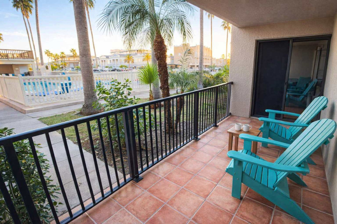 Relaxing Poolside Patio | Steps to Resort Pool & Palm-Lined Grounds | Bright Condo with Outdoor Seating & Tropical Views