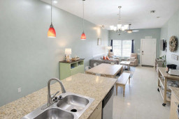 Modern Coastal Retreat: Open-Concept Living, Granite Kitchen Island, Cozy Dining Nook, Plush Sofa, Smart TV, Natural Light, Steps to Beach & Dining