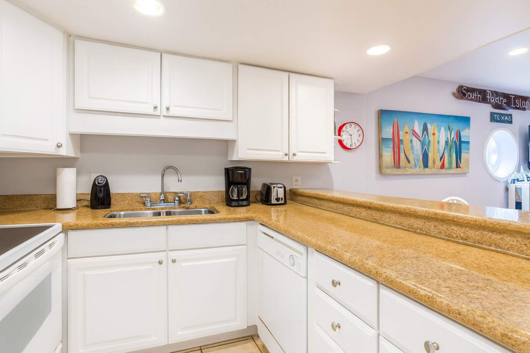 Bright Coastal Kitchen Near South Padre Beach
Enjoy clean, well-lit kitchen featuring white cabinetry, granite countertops, and modern appliances. Surfboard art & South Padre Island décor add coastal charm—perfect for relaxing mornings with coffee.