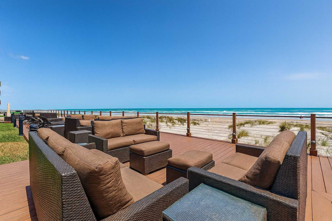 Oceanfront Deck with Plush Seating & Panoramic Views
Relax on a spacious beachfront deck with plush wicker seating, glass railing, and stunning ocean views. Perfect for morning coffee or sunset cocktails. Steps from the sand—ideal for families.
