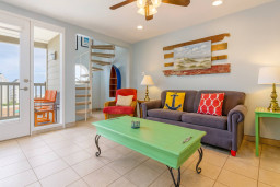 Bright Beachside Living Room w/ Balcony & Spiral Staircase
Coastal charm meets comfort in this sunlit living room featuring a spiral staircase, balcony access, vibrant décor, and beach-themed accents. Perfect for relaxing after poolside fun.