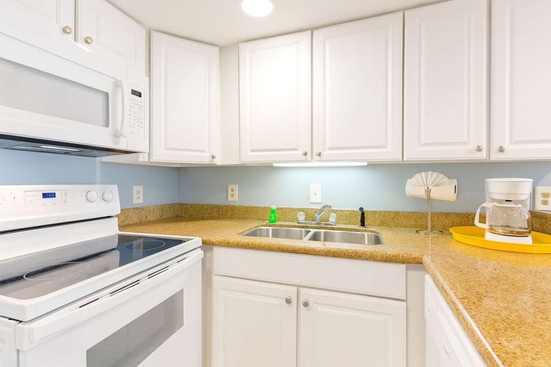 Bright Modern Kitchen with Full Amenities
Sparkling clean kitchen with white cabinetry, granite countertops & full appliances. Well-lit & fully equipped—perfect for cooking and enjoying stay.