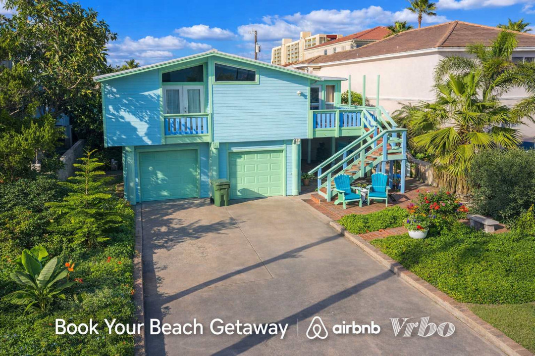Bright Coastal Retreat | 2BR Elevated Home w/ Balcony, Garage, Tropical Garden | Walk to Beach & Dining