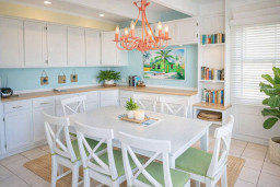 Bright Coastal Dining Retreat | Tropical Art | Pink Chandelier | Books & Games | Family-Friendly