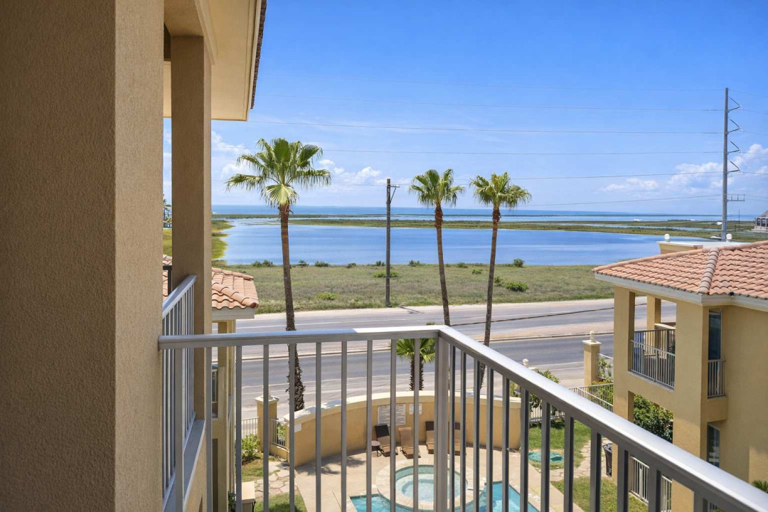 Coastal retreat with pool views, palm trees, and serene water backdrop—perfect for relaxing getaways. Steps from the beach, bright interiors, and peaceful surroundings ideal for couples or small families.