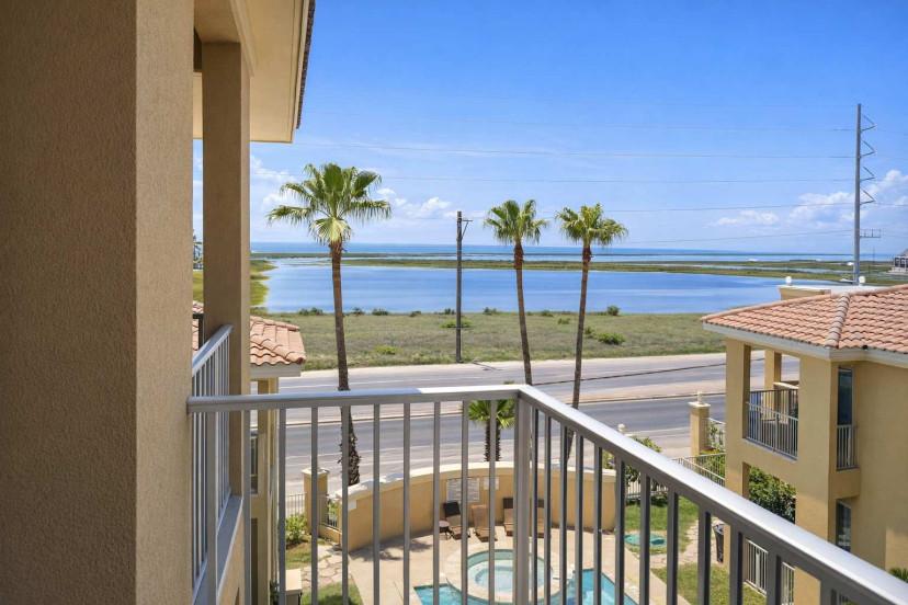 Coastal retreat with pool views, palm trees, and serene water backdrop—perfect for relaxing getaways. Steps from the beach, bright interiors, and peaceful surroundings ideal for couples or small families.