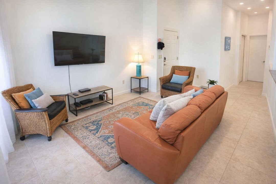 Cozy Beach-Inspired Living Room | Bright, Inviting Space with Smart TV, Wicker Seating & Coastal Decor | Perfect for Relaxing After a Day at the Shore