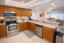 Warm, inviting kitchen flows into a bright living space—perfect for relaxed mornings or shared meals. Clean lines, natural light, and coastal charm create a welcoming feel that guests instantly connect with.