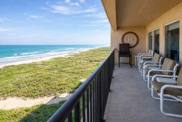 Serene coastal retreat with panoramic ocean views from a private balcony—perfect for slow mornings and sunset unwinds. Thoughtfully arranged seating invites relaxation, capturing the essence of beachside living without overstating amenities.