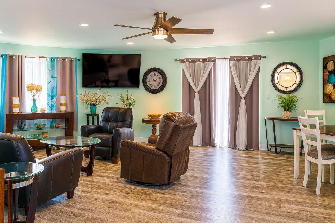 Spacious Mint-Green Living Room | Recliners, Smart TV, Natural Light, Dining Area, Stylish Decor
