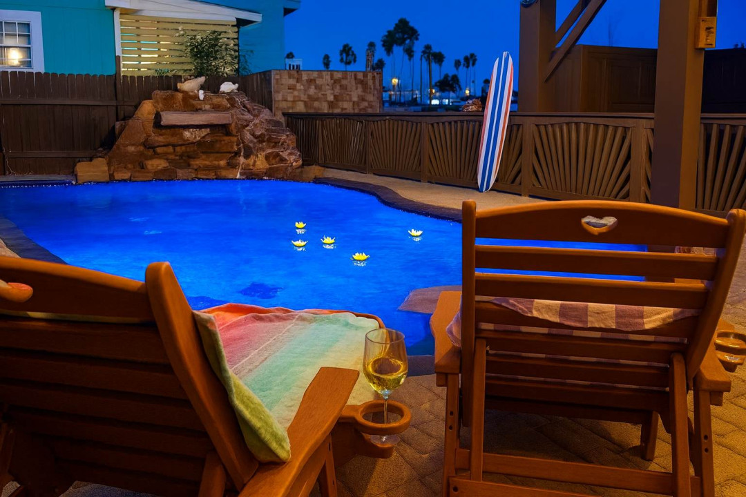 Palm-Lit Poolside Escape w/ Waterfall & Lounge Deck
Relax under the stars by a glowing pool with floating candles, waterfall feature, and cozy lounge chairs. Perfect for romantic evenings or laid-back beach vibes.