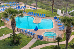 Resort-style pool & outdoor tub oasis with palm trees, tiki hut, and blue loungers — perfect for relaxing under the sun or stargazing at night. Steps from nature trails and minutes to the beach.