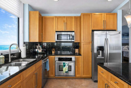 Modern Kitchen with Ocean View – Stainless Steel Appliances, Granite Counters, Double Sink, and Sleek Cabinetry. Bright, Clean, and Fully Equipped for Your Stay.