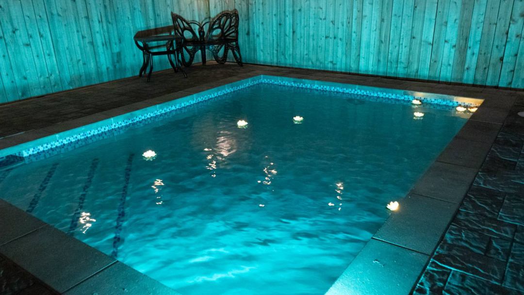 Serene Glowing Poolside Retreat Oasis
Dive into bliss at this enchanting pool haven, illuminated by mesmerizing blue lights at night. Lounge on stylish chairs by the wooden fence, surrounded by sleek stone decking.