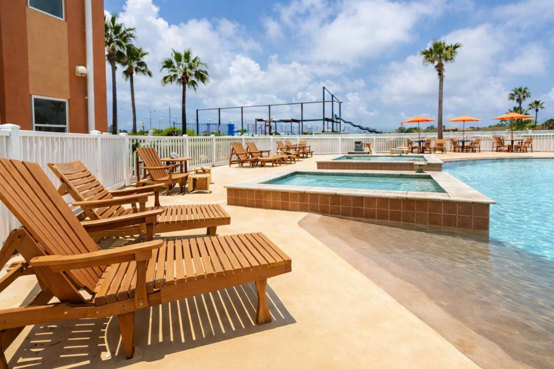 A bright, breezy poolside escape where sunlight dances on calm water and palm trees frame the day. A simple, refreshing space that invites slow mornings, easy afternoons, and relaxed moments that feel naturally coastal and carefree.