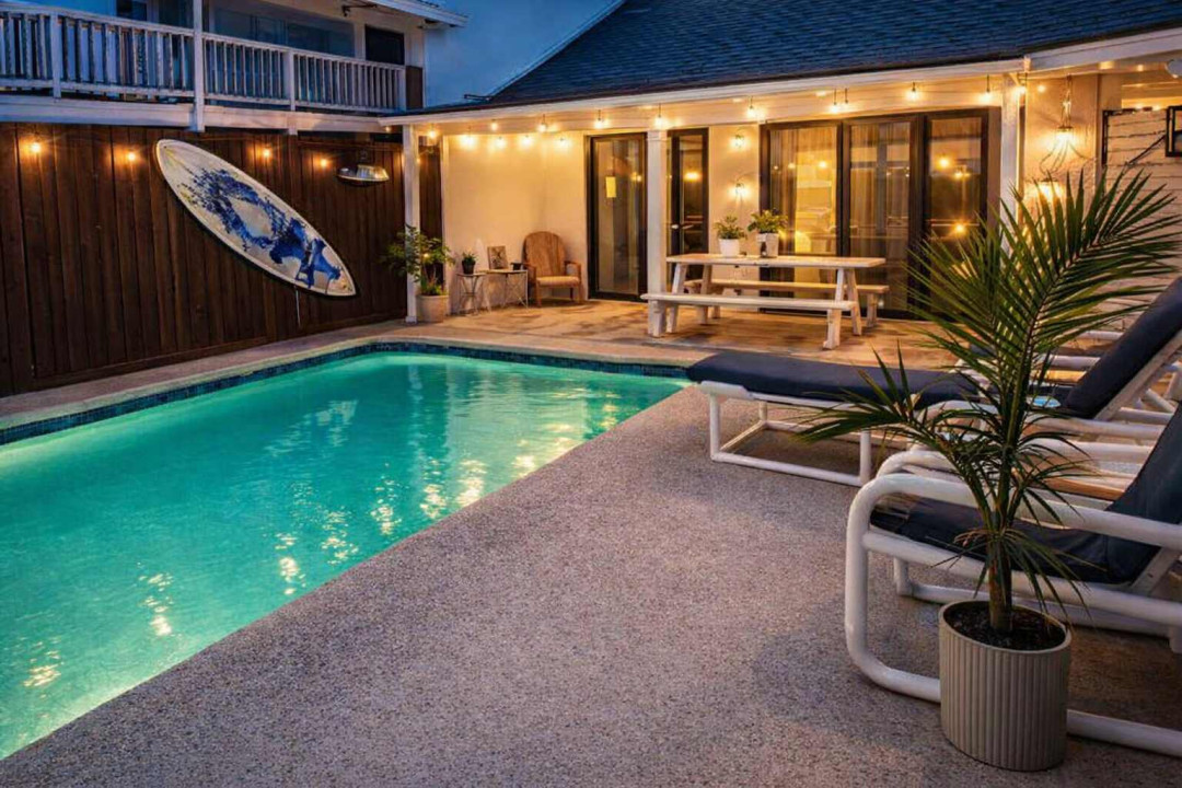 A twilight retreat where coastal charm meets calm—this backyard oasis invites guests to unwind beside a softly lit pool, framed by warm string lights and natural textures. Perfect for slow evenings and effortless relaxation.