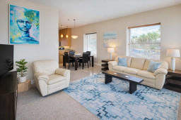 Bright & Modern Coastal Retreat – Steps to Dining & Beach!  
Spacious living + dining, vibrant art, plush seating, full kitchen, and natural light. Ideal for families or groups seeking comfort and style near the shore.